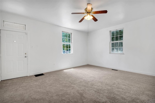 carpeted empty room featuring ceiling fan