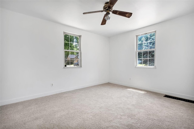 carpeted spare room with ceiling fan