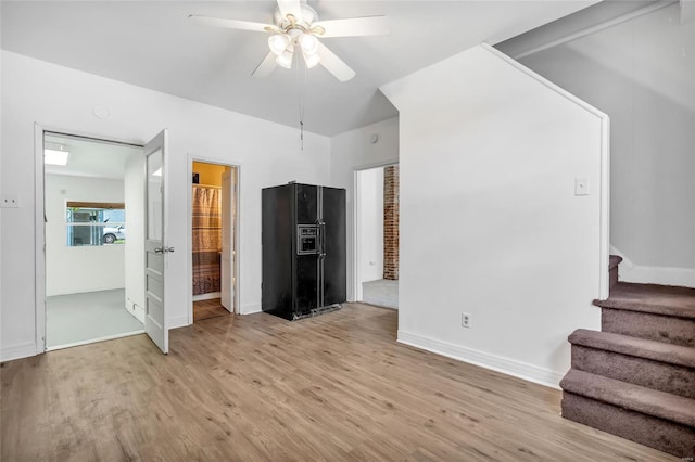 unfurnished living room featuring light hardwood / wood-style flooring and ceiling fan