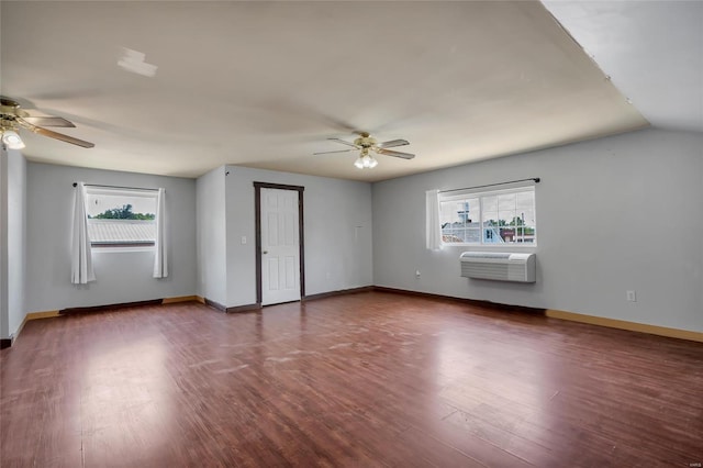 spare room featuring a wall mounted air conditioner, plenty of natural light, and ceiling fan