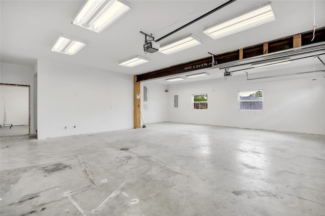 garage featuring electric panel and a garage door opener