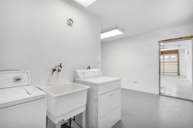 clothes washing area with washer and clothes dryer and sink