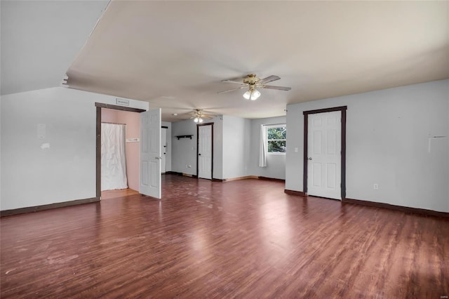 spare room featuring ceiling fan, dark hardwood / wood-style flooring, and lofted ceiling