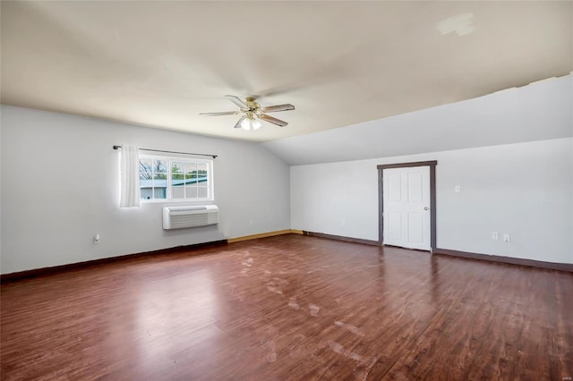 bonus room featuring vaulted ceiling, a wall unit AC, ceiling fan, and dark wood-type flooring