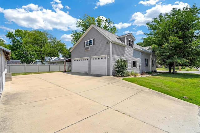 view of side of property with a lawn and a garage