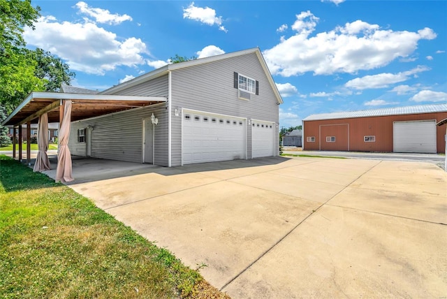 view of side of home featuring a carport and a garage