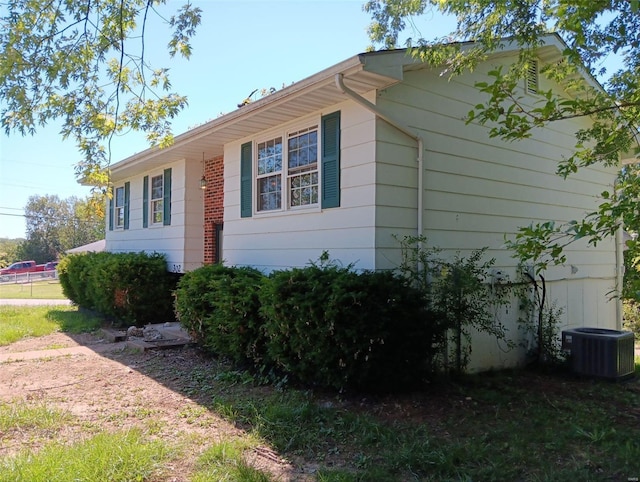 view of property exterior with central AC