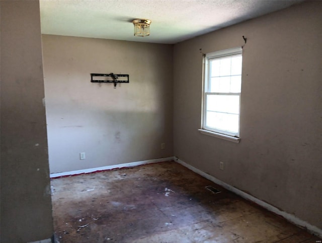 empty room featuring a textured ceiling