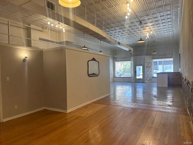 spare room with dark hardwood / wood-style floors and a high ceiling