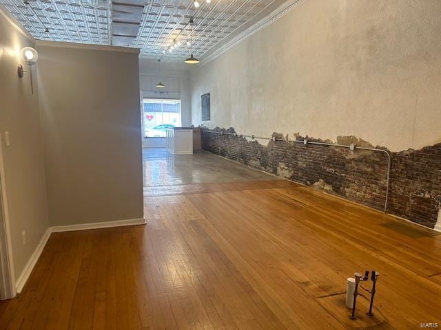 hallway featuring hardwood / wood-style floors and ornamental molding