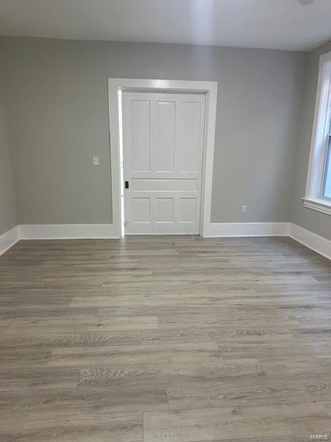 empty room with light hardwood / wood-style flooring