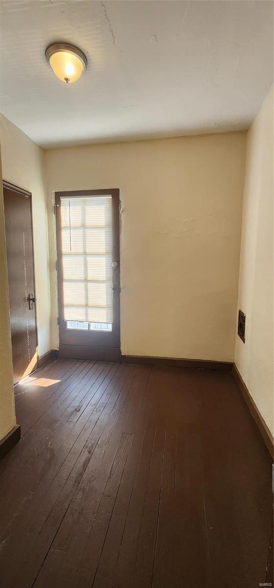 empty room featuring dark wood-type flooring