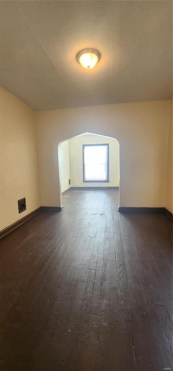 bonus room with dark hardwood / wood-style flooring