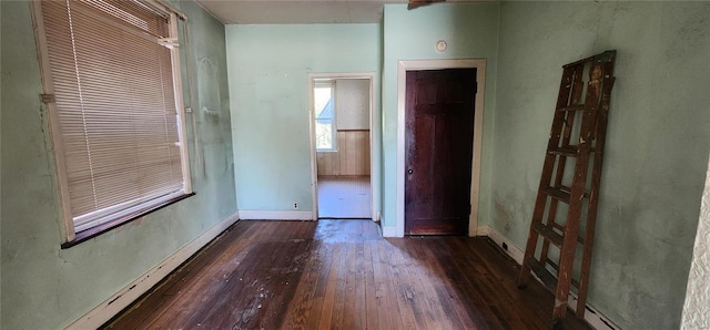 unfurnished room featuring dark hardwood / wood-style flooring