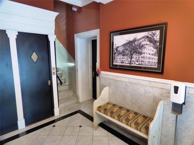 tiled entrance foyer featuring ornate columns