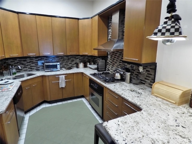 kitchen featuring appliances with stainless steel finishes, tasteful backsplash, wall chimney exhaust hood, and sink