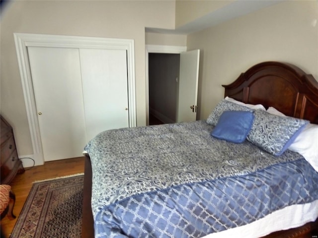 bedroom with hardwood / wood-style floors and a closet