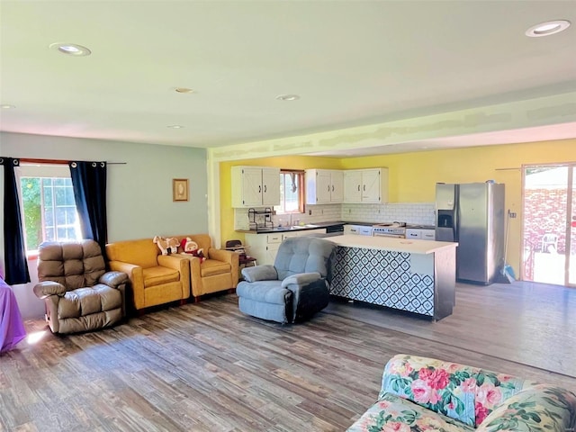 living room with light wood-type flooring and sink