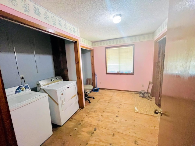 laundry area featuring a textured ceiling and independent washer and dryer