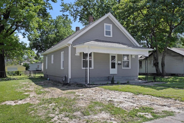 bungalow-style home featuring covered porch and a front yard