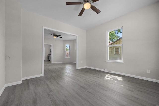 spare room with hardwood / wood-style floors, plenty of natural light, and ceiling fan