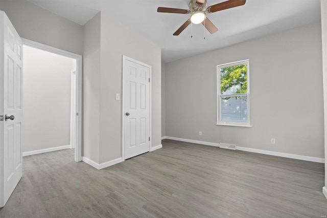 unfurnished bedroom with ceiling fan and light hardwood / wood-style floors