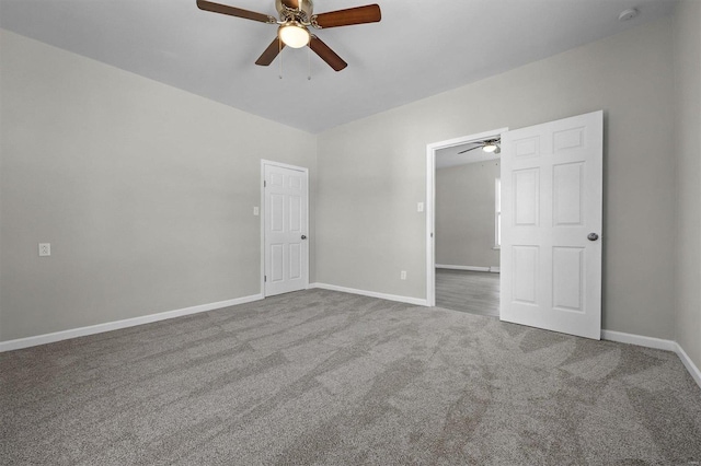 empty room with carpet flooring and ceiling fan