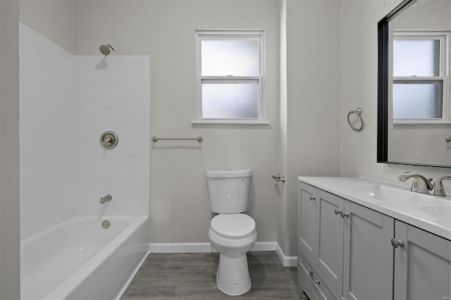 full bathroom with a wealth of natural light, vanity, tub / shower combination, and toilet