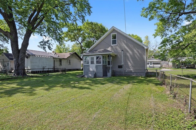 back of house with a yard