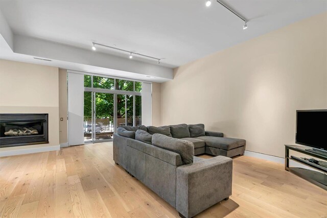 living room featuring track lighting and light hardwood / wood-style floors