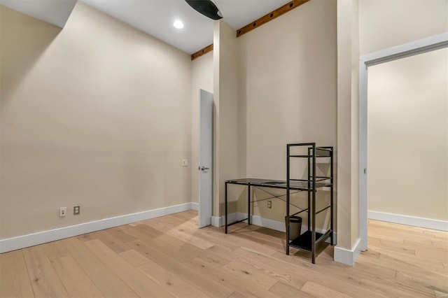 interior space with beamed ceiling and light wood-type flooring