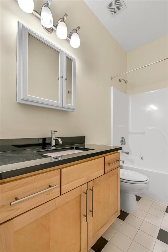 full bathroom with tile patterned flooring, vanity, bathing tub / shower combination, and toilet