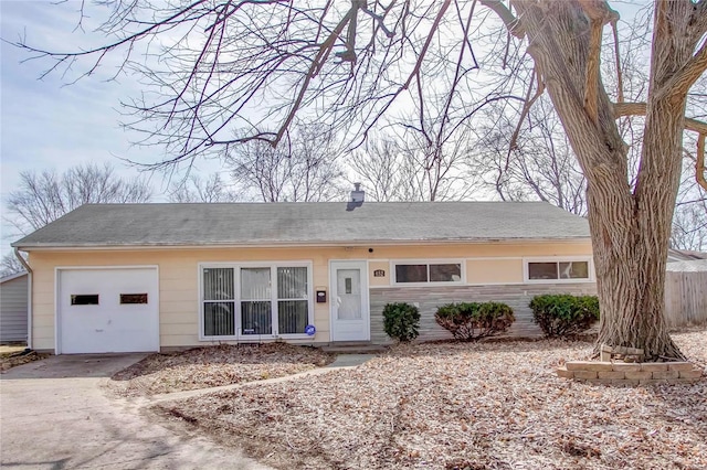 ranch-style house with a garage and driveway