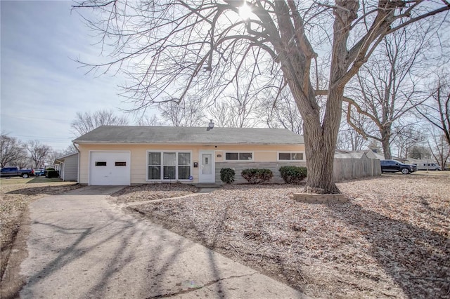 single story home with aphalt driveway and an attached garage