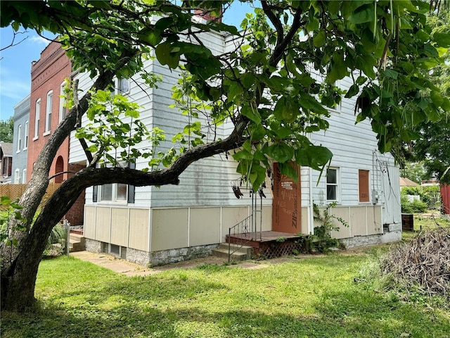 view of property exterior with a yard