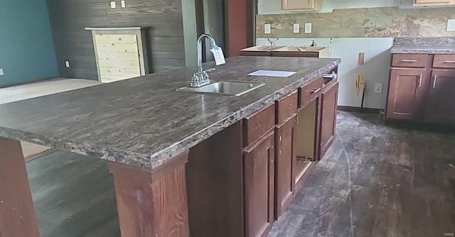 kitchen with an island with sink, tasteful backsplash, and sink