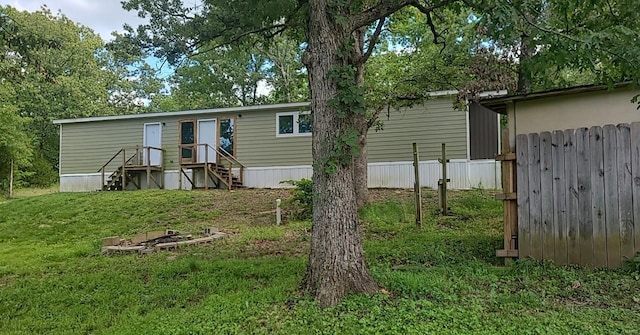 rear view of house featuring a yard