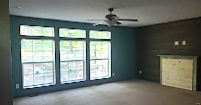 unfurnished living room with ceiling fan