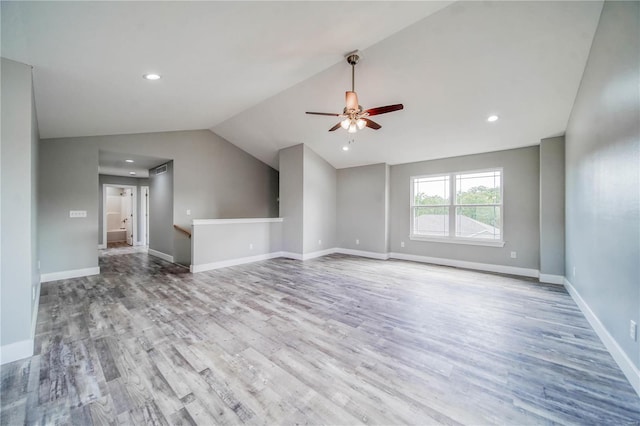 spare room with wood-type flooring, ceiling fan, and vaulted ceiling