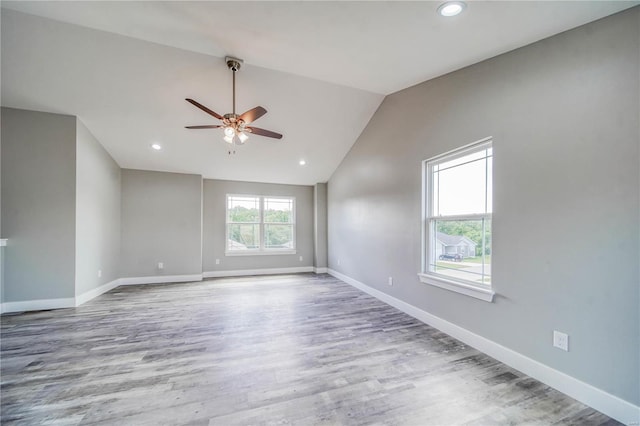 spare room with lofted ceiling, hardwood / wood-style flooring, and ceiling fan