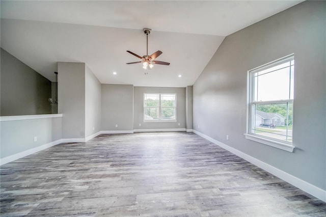 spare room featuring lofted ceiling, ceiling fan, and wood-type flooring