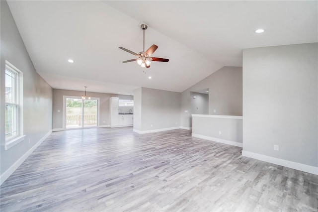 unfurnished living room featuring lofted ceiling, ceiling fan, and light wood-type flooring