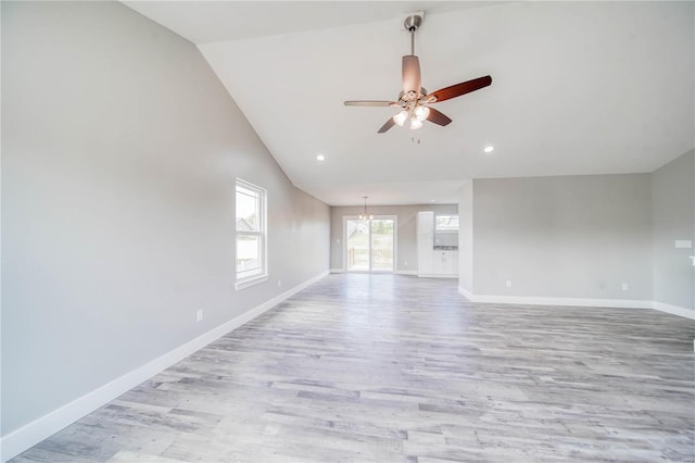 empty room with light hardwood / wood-style floors, high vaulted ceiling, and ceiling fan