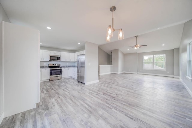 unfurnished living room featuring light hardwood / wood-style floors and ceiling fan with notable chandelier