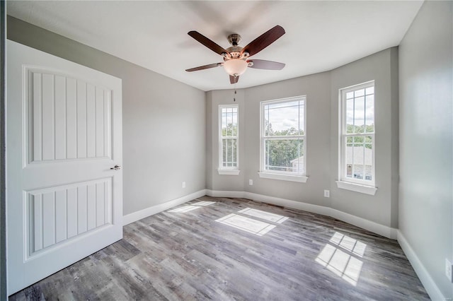 empty room featuring ceiling fan and hardwood / wood-style flooring