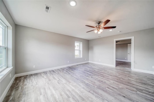 empty room featuring ceiling fan and hardwood / wood-style flooring