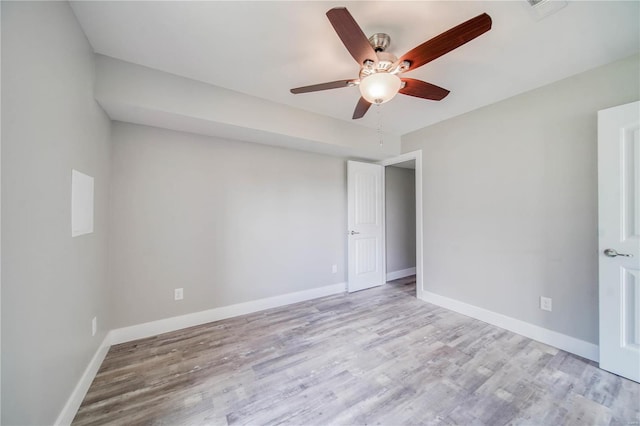 empty room featuring ceiling fan and light hardwood / wood-style floors