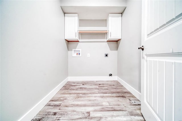 clothes washing area featuring electric dryer hookup, light hardwood / wood-style flooring, cabinets, and hookup for a washing machine