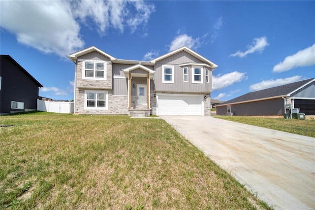 bi-level home featuring a garage and a front yard