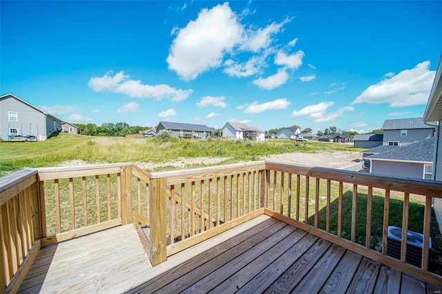 wooden deck featuring a lawn